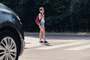 girl waiting to enter crosswalk