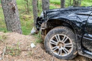 black car on dirt mound