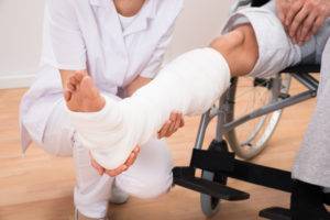 doctor helping man in a cast